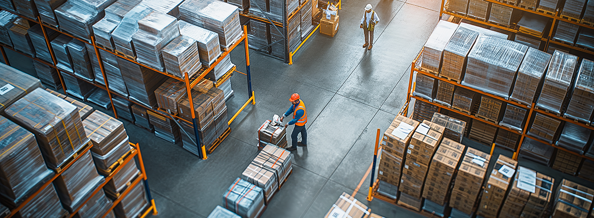 Workers inside a manufacturing warehouse.